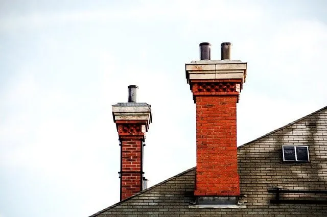 A chimney made of bricks on a roof.