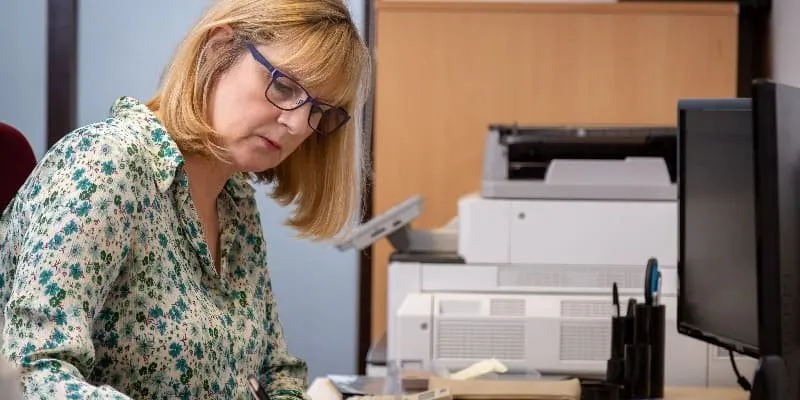 Lesley Castle working in the office