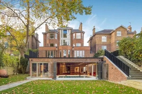 Rear of a large brick house in Holland Park with a glazed extension, surveyed by THS Concepts