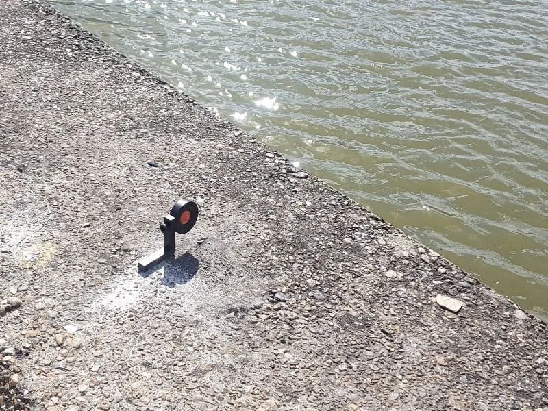 Monitoring prism fixed to a river wall