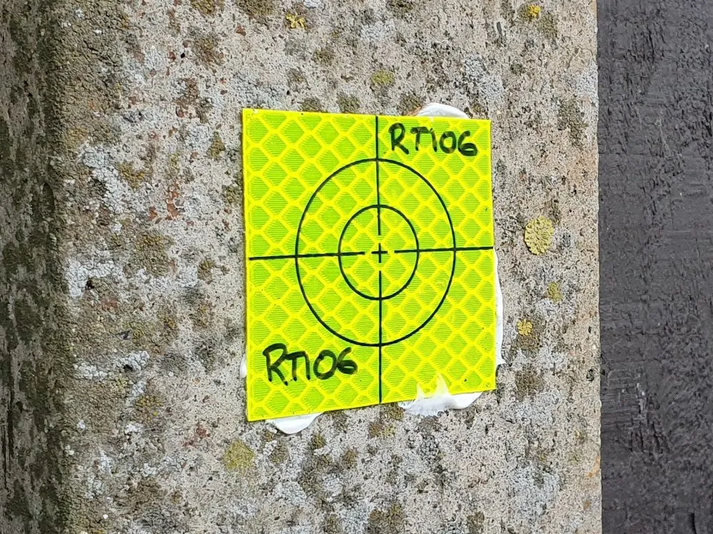 Reflective monitoring target fixed to a concrete wall