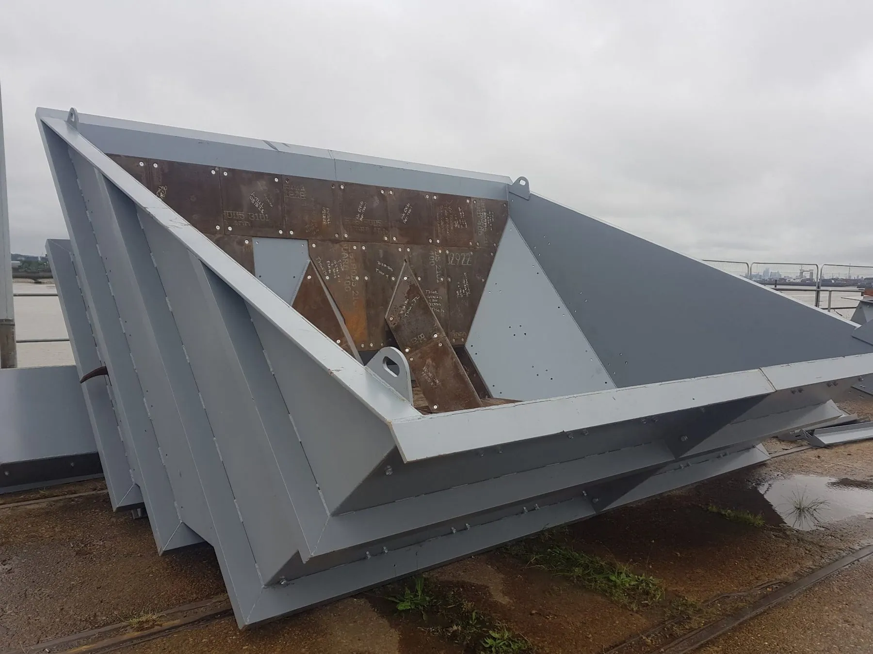 A new steel hopper waiting on the wharf