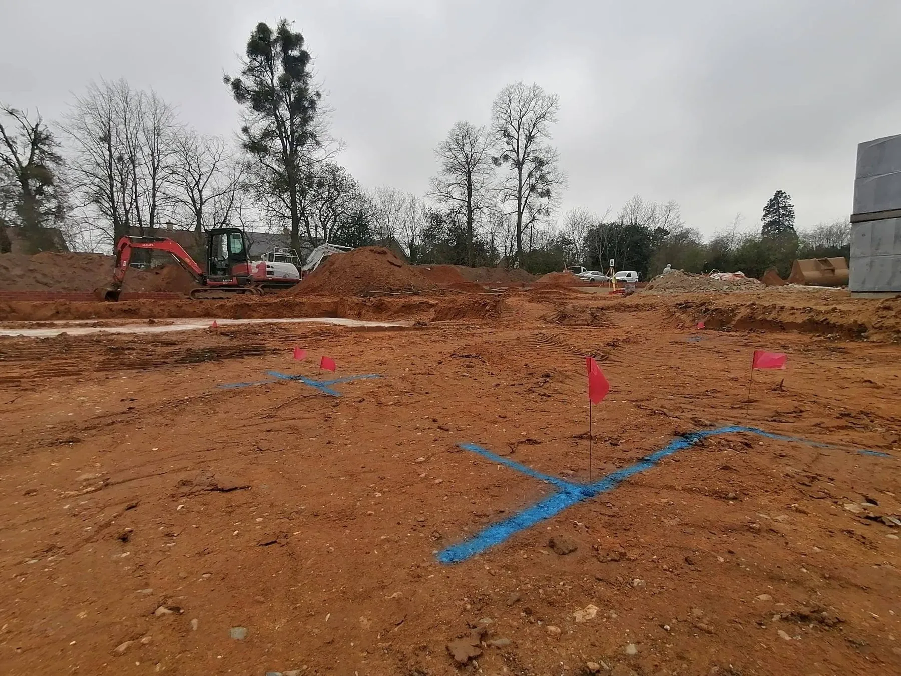 Setting out pegs and flags marking footings on a cleared site