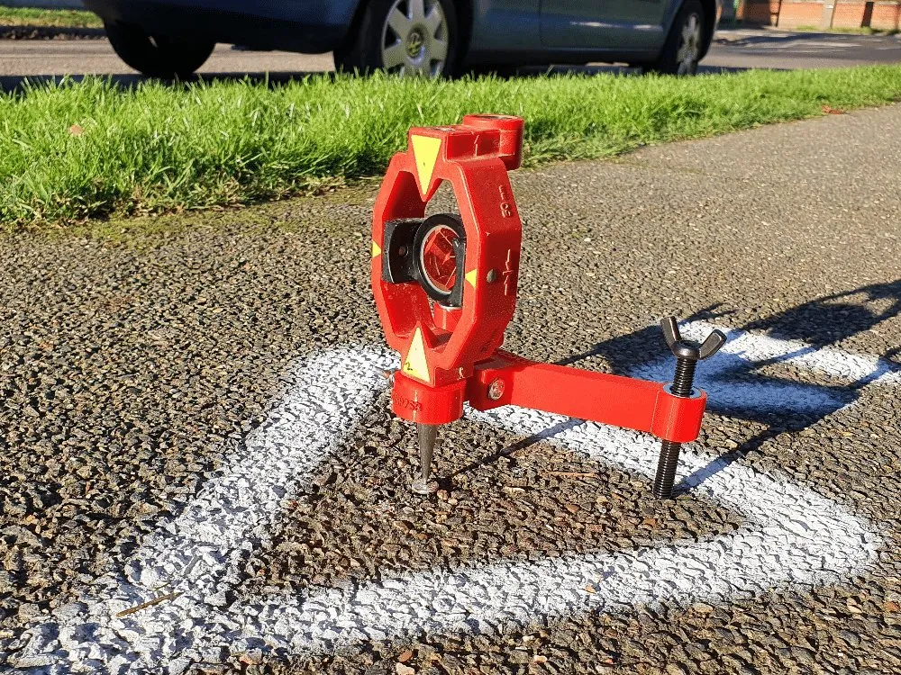 THSP75 holding a mini prism over a survey nail