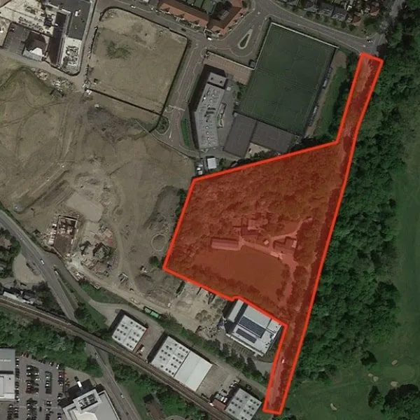 Aerial photo of a large commercial site outlined in red, an example of a larger topographical survey